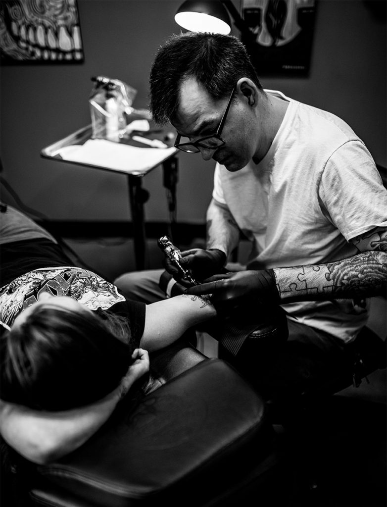 artist Thomas tattooing